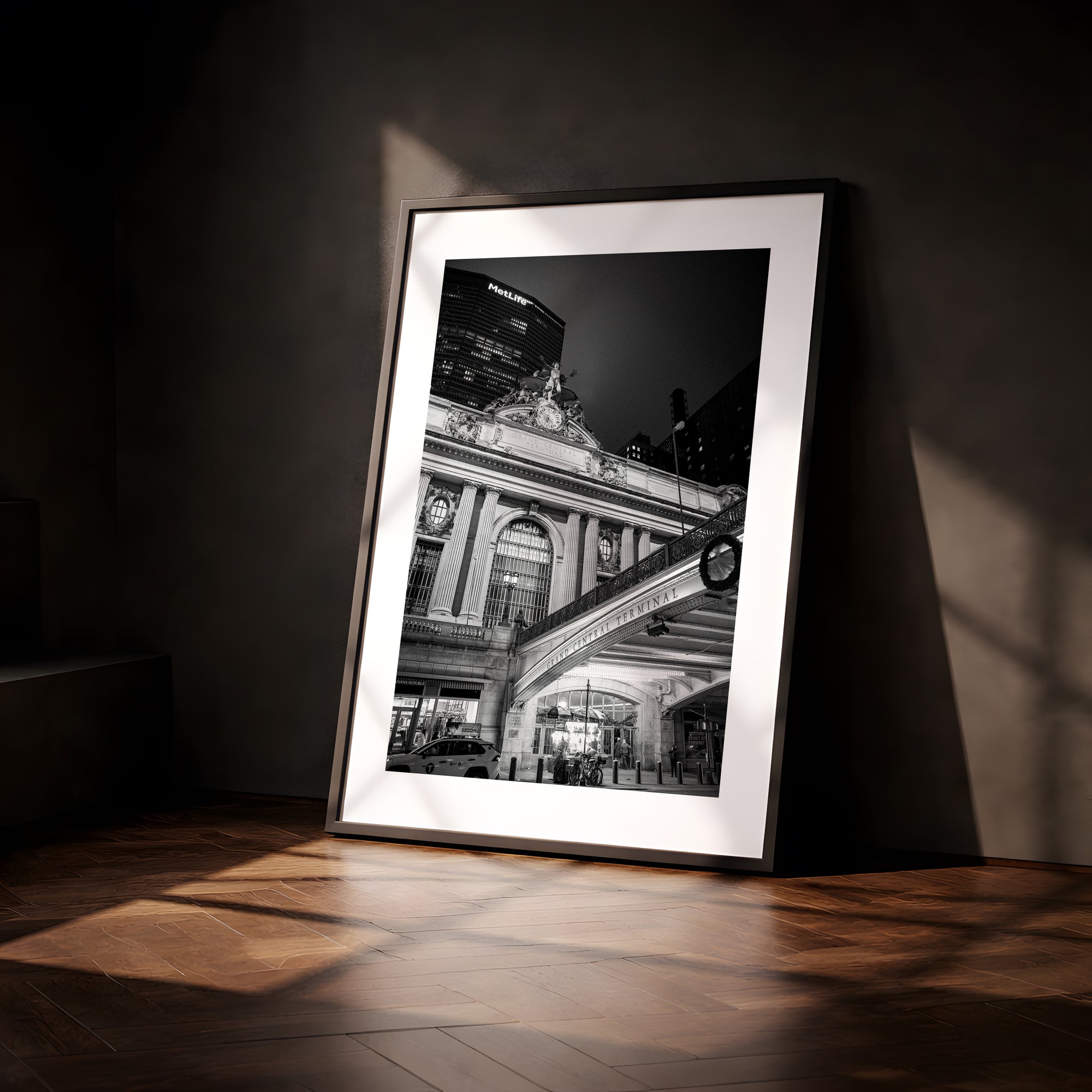 NYC Grand Central from the Left, 42nd Street framed in black above a terracotta velvet sofa, gray plaster wall — Good Beans NYC.
