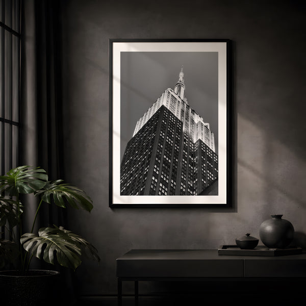 NYC Empire State Building, A Different Angle framed in black on a gallery wall with a viewer in a straw hat in front — Good Beans NYC.