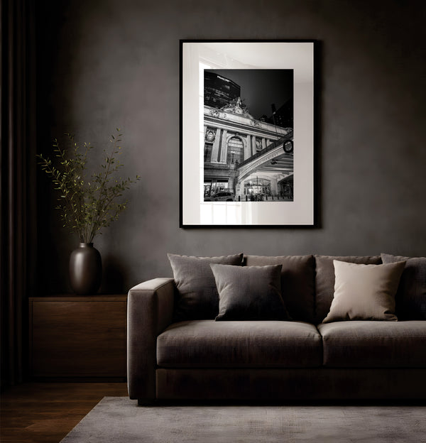 NYC Grand Central from the Left, 42nd Street framed in black on a gallery wall with a viewer in a straw hat in front — Good Beans NYC.