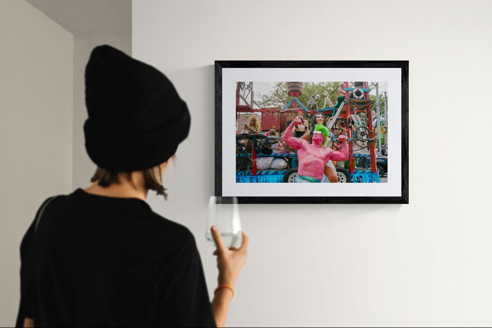 NYC Mermaid Parade Pink Hulk — Coney Island framed in black on a gallery wall with a side-profile viewer in a dark coat — Good Beans NYC.