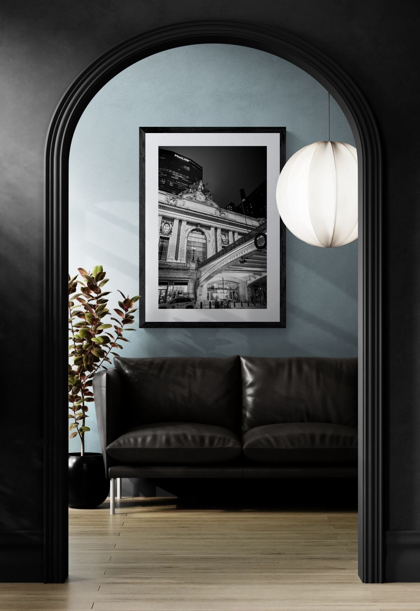 NYC Grand Central at Night, East 42nd Street framed in black on a gallery wall with a side-profile viewer in a dark coat — Good Beans NYC.