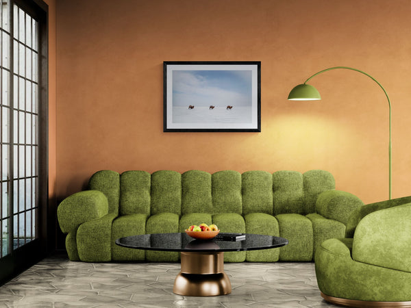 Bactrian Camels on the Mongolian Salt Flat, Gobi framed in black above a terracotta velvet sofa, gray plaster wall — Good Beans NYC.