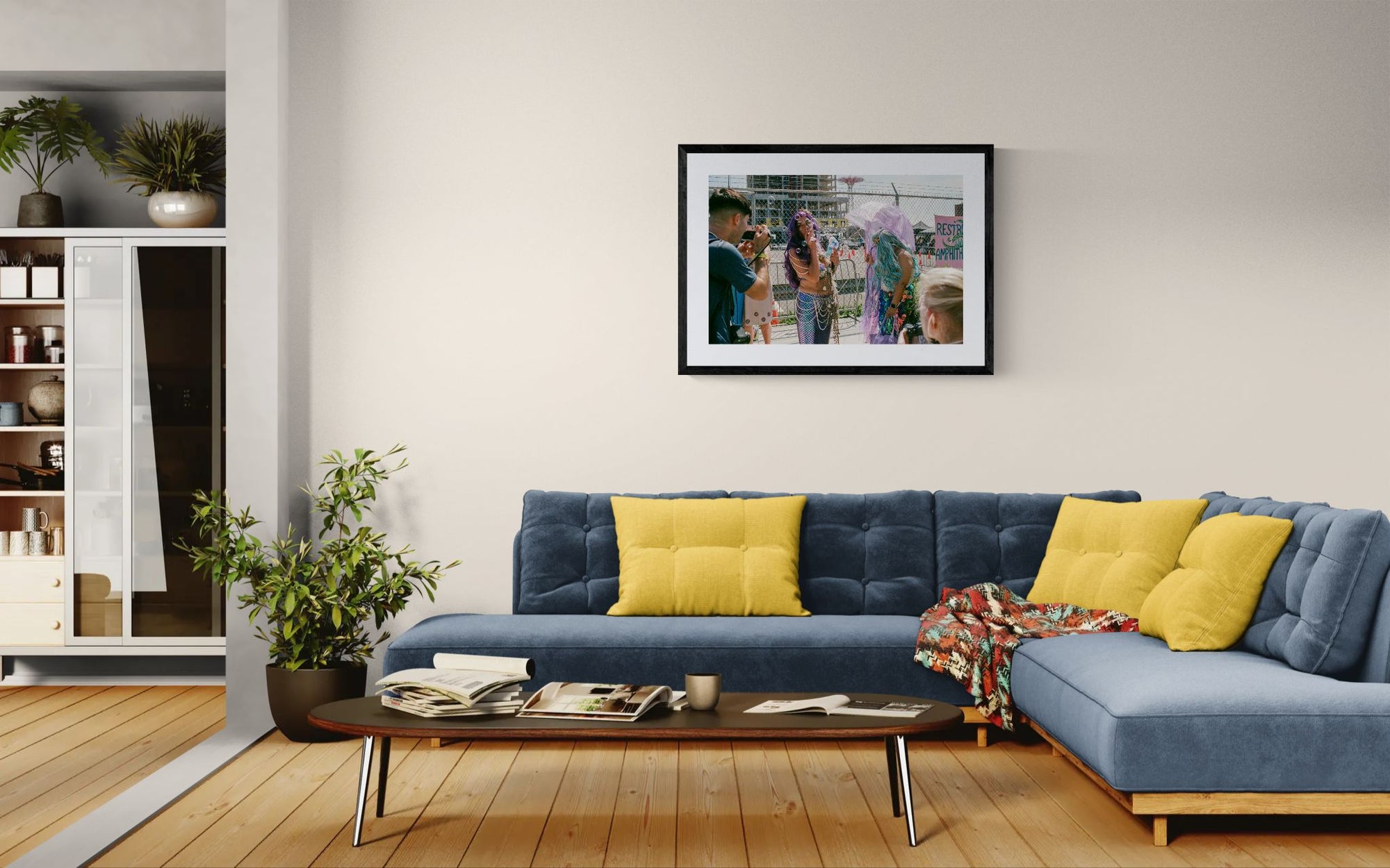 NYC Mermaid Parade Smoking, Coney Island framed in black above a beige sofa, sunlit yellow plaster wall — Good Beans NYC.