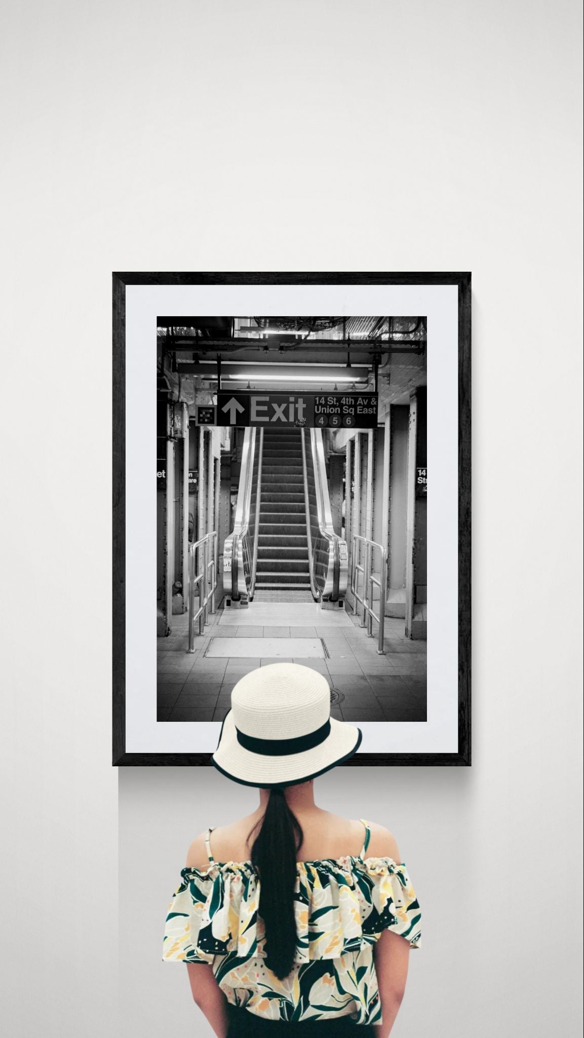 NYC Subway Union Square 4 5 6 Heading Up, Portals Series framed in black on a gallery wall with a viewer in a straw hat in front — Good Beans NYC.