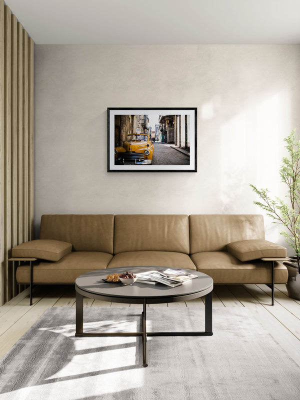 Cuba Taxi, Old Havana framed in black above a terracotta velvet sofa, gray plaster wall — Good Beans NYC.