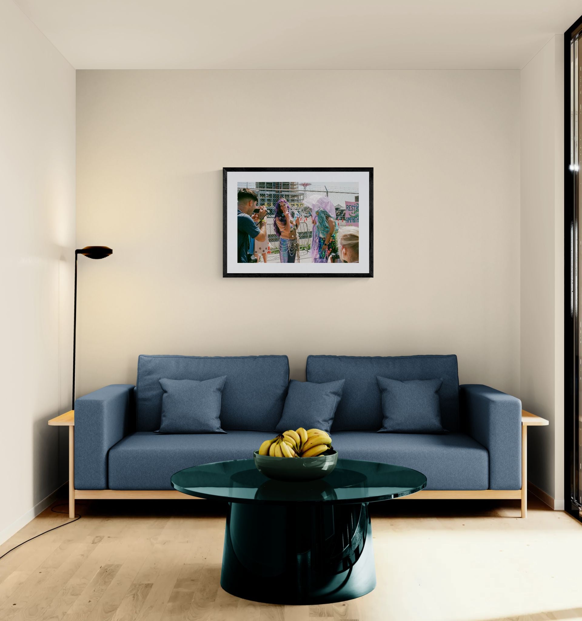 NYC Mermaid Parade Smoking, Coney Island framed in black above a brown leather sectional, teal wall, gold pendant lamp — Good Beans NYC.