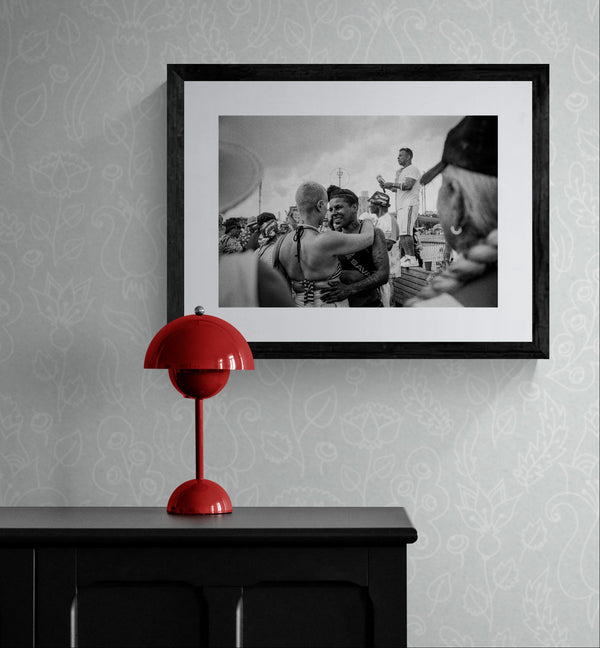 NYC Coney Island Girl Couple, Boardwalk framed in black above a terracotta velvet sofa, gray plaster wall — Good Beans NYC.