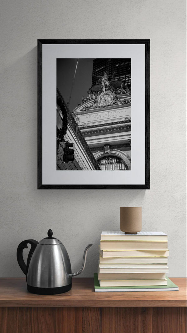 NYC Grand Central from the Right, Mercury Statue framed in black above a beige sofa, sunlit yellow plaster wall — Good Beans NYC.