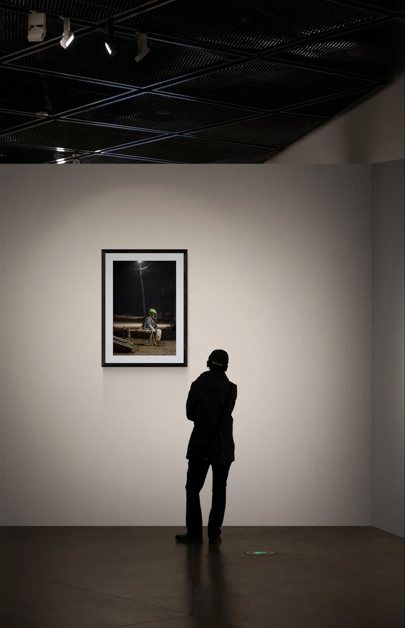 India Man Under Streetlight, Jodhpur framed in black above a terracotta velvet sofa, gray plaster wall — Good Beans NYC.