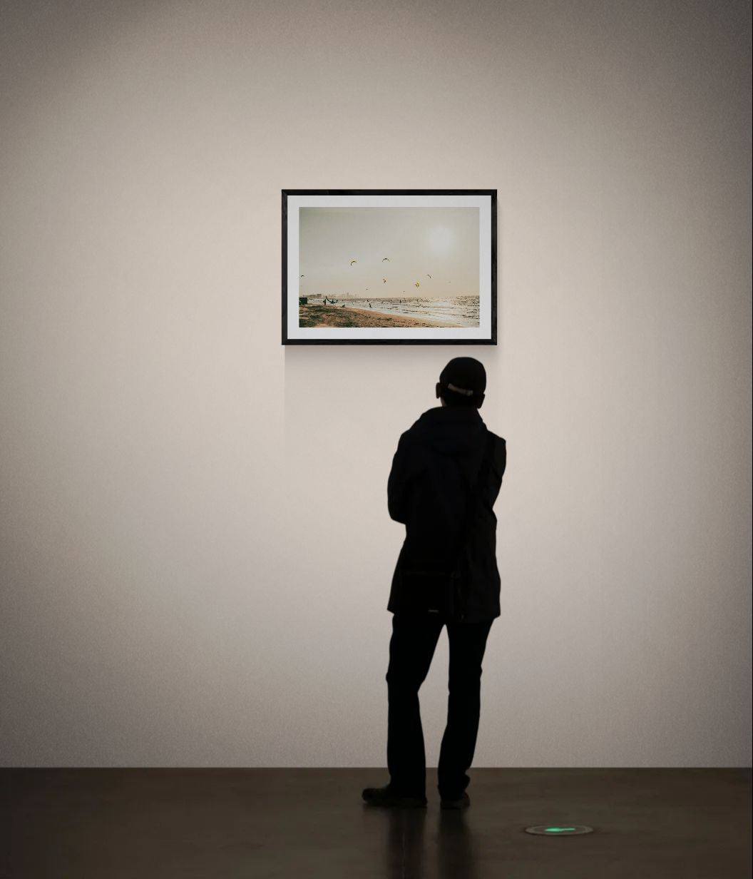 Cartagena Kite Beach — Colombia framed in black above a terracotta velvet sofa, gray plaster wall — Good Beans NYC.