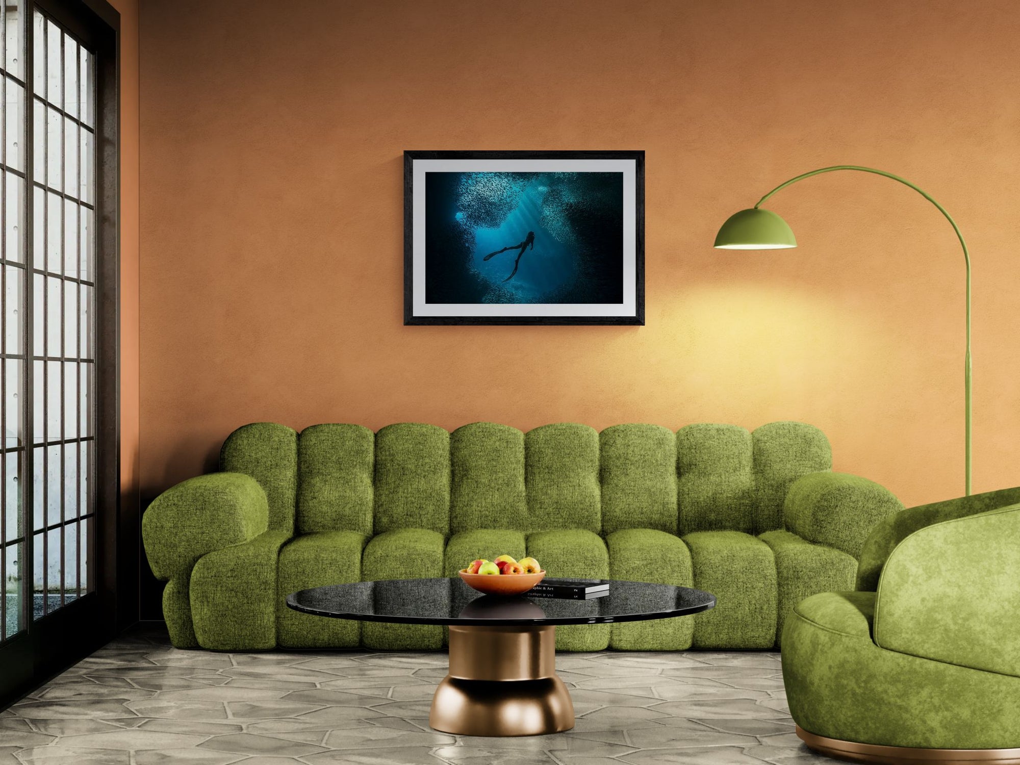 Free Diver Off Mexico Coast, Photo by Karim Iliya framed in black above a terracotta velvet sofa, gray plaster wall — Good Beans NYC.