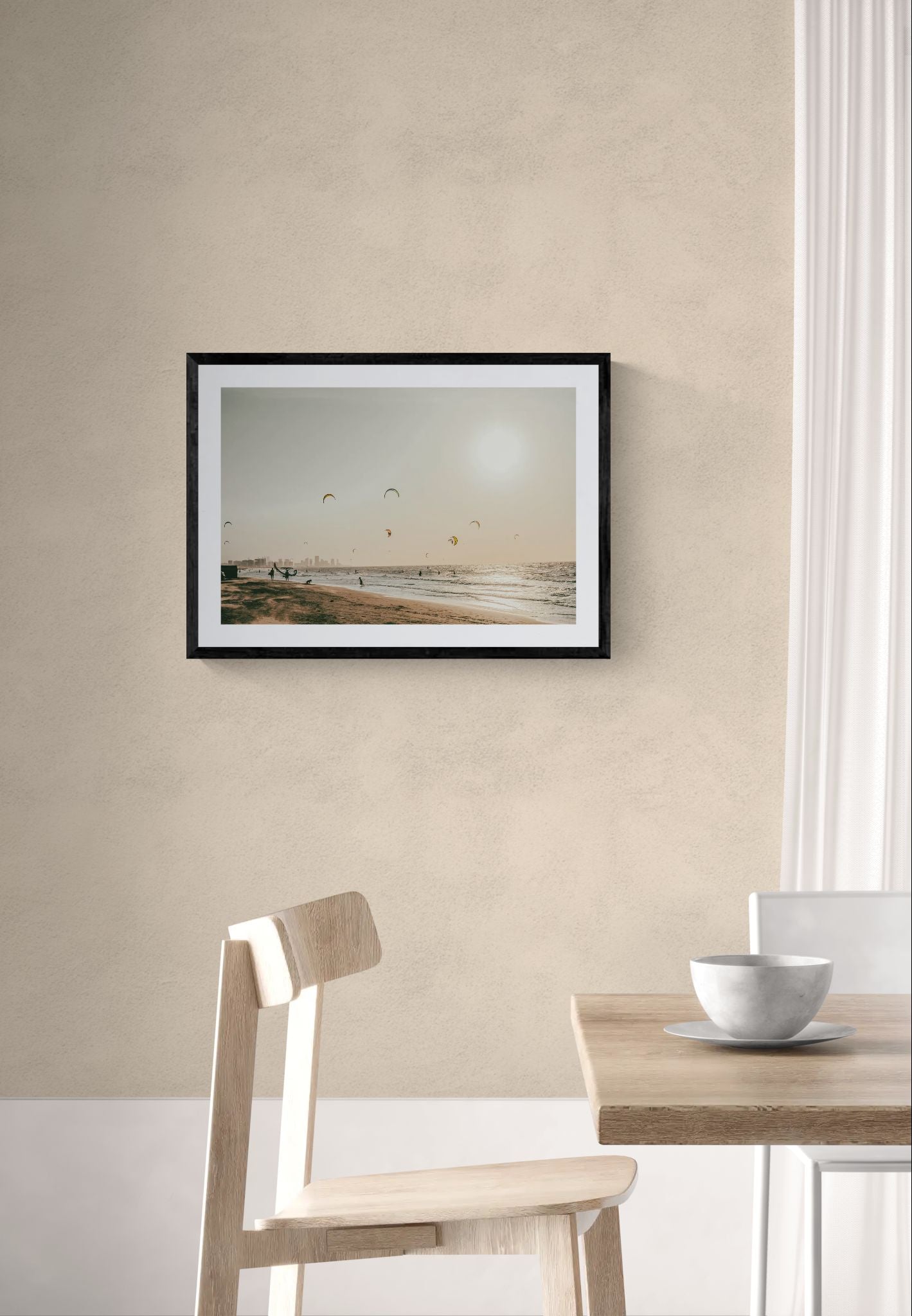 Cartagena Kite Beach — Colombia framed in black above a brown leather sectional, teal wall, gold pendant lamp — Good Beans NYC.