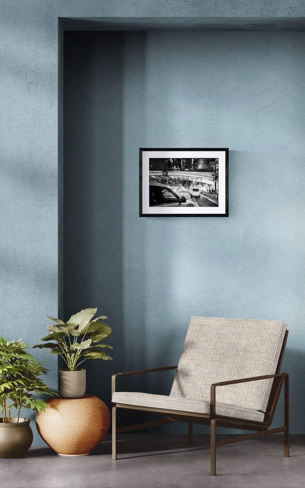 NYC Grand Central at Night, East 42nd Street framed in black above a beige sofa, sunlit yellow plaster wall — Good Beans NYC.