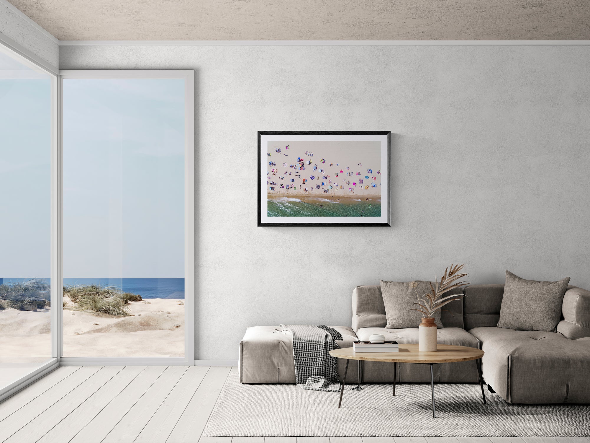 Barcelona from the Air, Barceloneta Beach by Karim Iliya framed in black above a terracotta velvet sofa, gray plaster wall — Good Beans NYC.