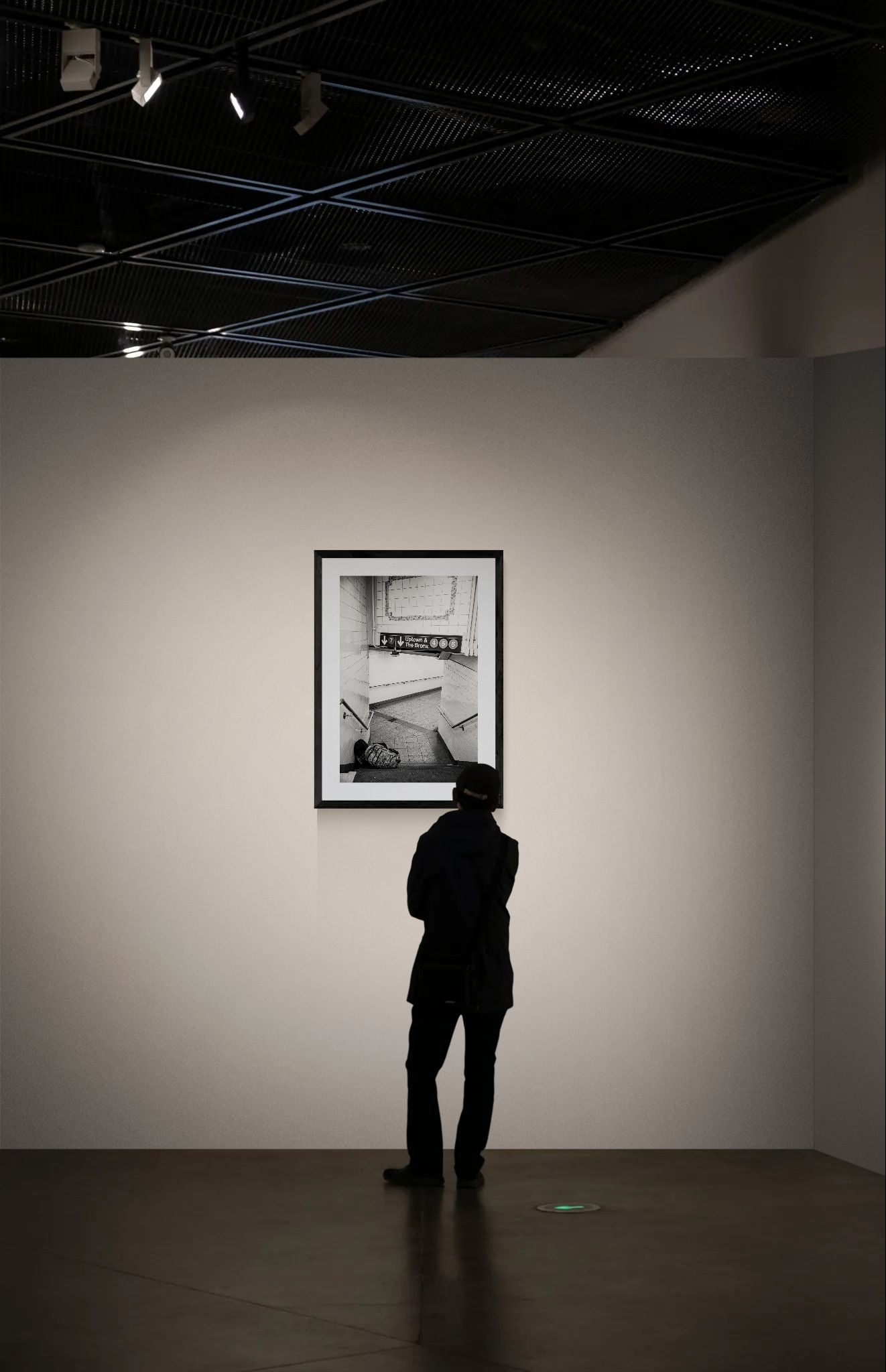 NYC Subway Uptown & Bronx Nap framed in black on a gallery wall with a viewer in a straw hat in front — Good Beans NYC.