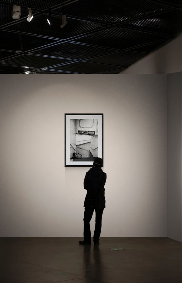 NYC Subway Uptown & Bronx Nap framed in black on a gallery wall with a viewer in a straw hat in front — Good Beans NYC.