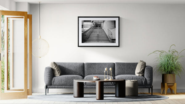 NYC Subway Grand Central Emptiness, Portals Series framed in black above a beige sofa, sunlit yellow plaster wall — Good Beans NYC.
