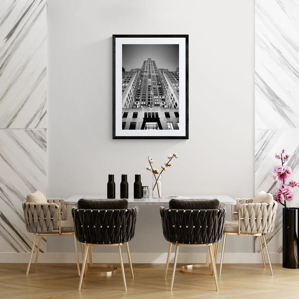 NYC Chrysler Building from Below, Art Deco Crown framed in black on a gallery wall with a side-profile viewer in a dark coat — Good Beans NYC.