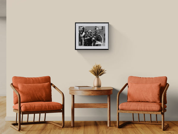 NYC Palestine Kiss, Washington Square Park framed in black above a beige sofa, sunlit yellow plaster wall — Good Beans NYC.