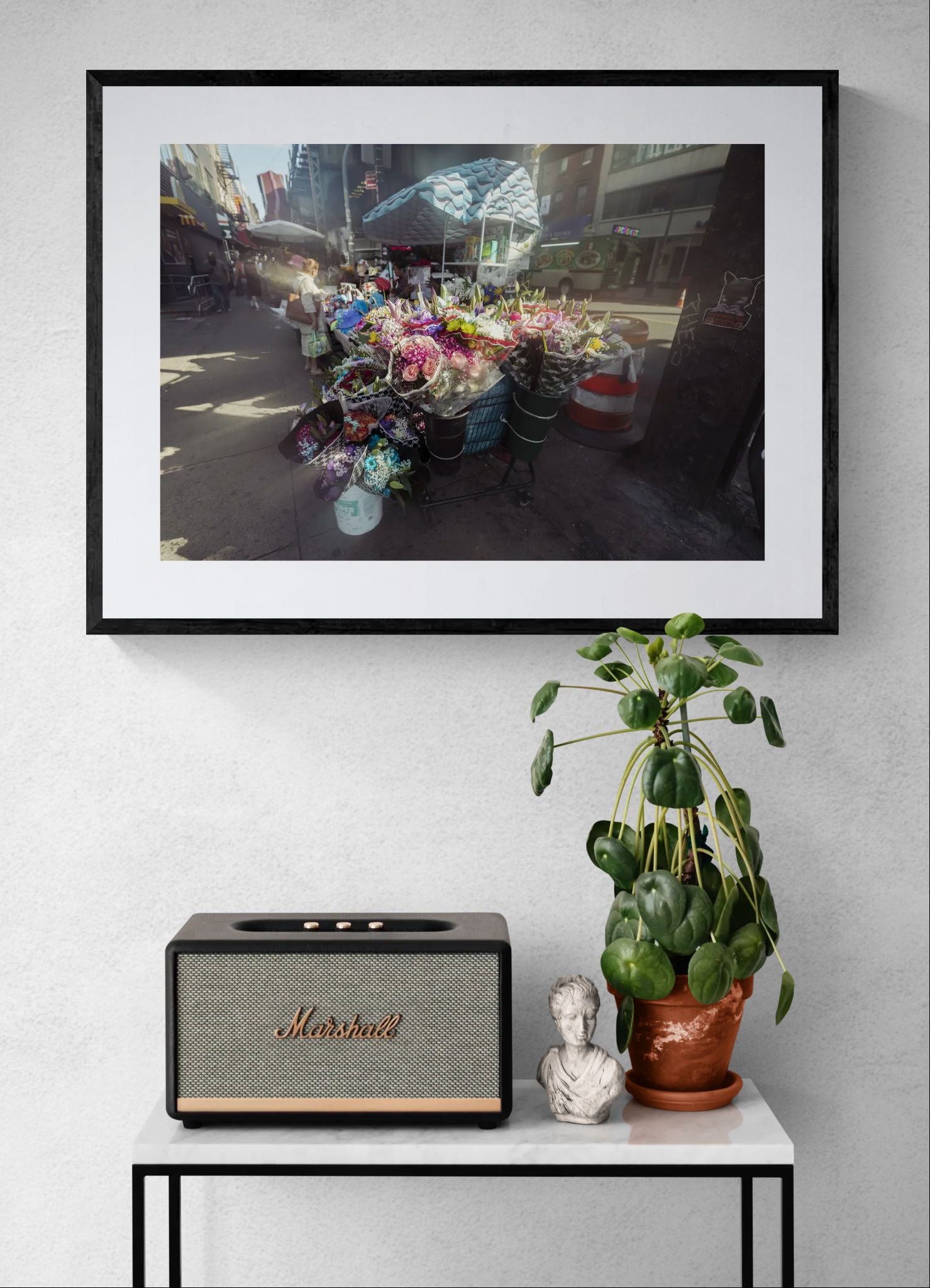 NYC Flower Cart Brooklyn — Under the J Train framed in black above a brown leather sectional, teal wall, gold pendant lamp — Good Beans NYC.