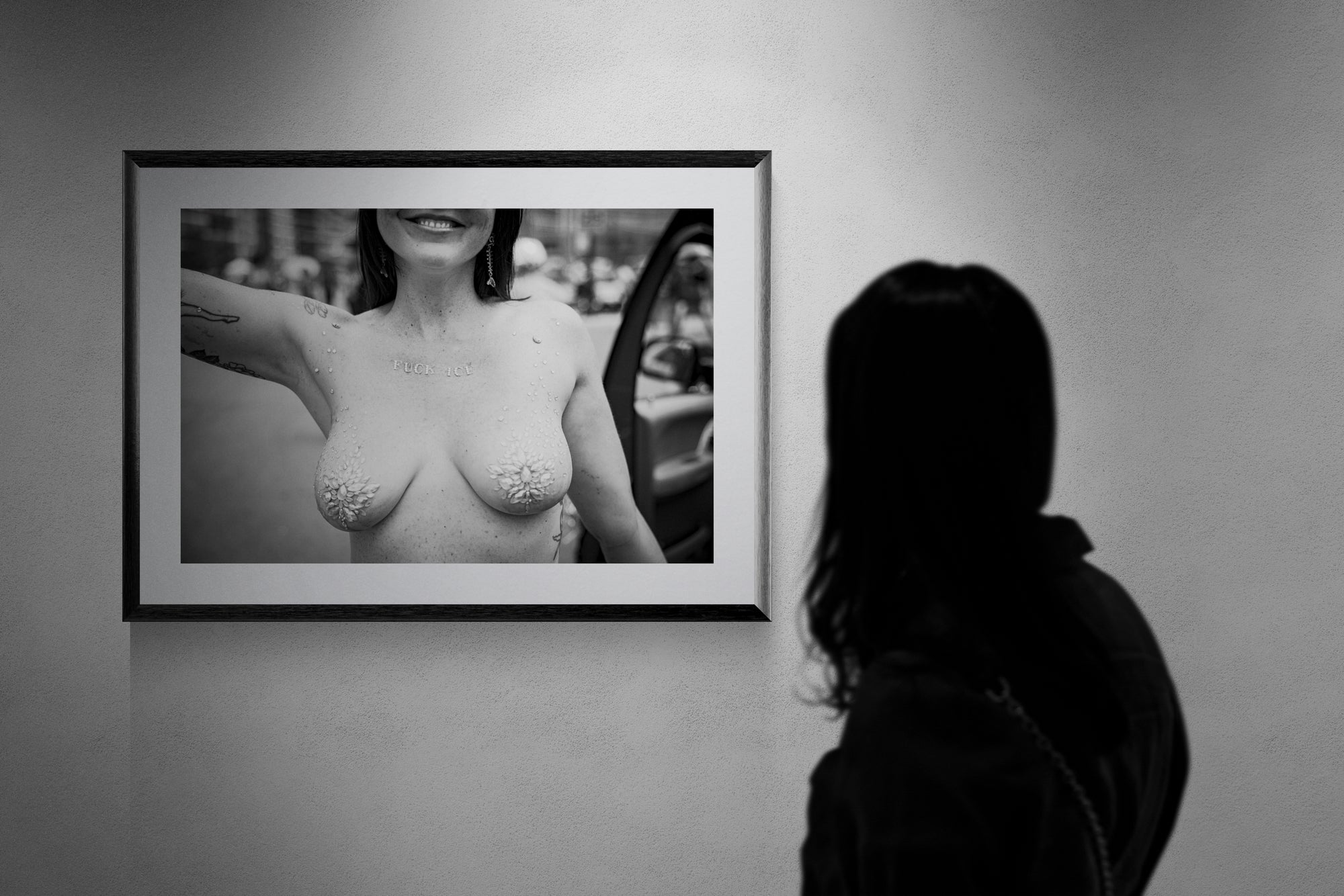 F*ck ICE Mermaid Protest Print — Coney Island framed in black on a gallery wall with a viewer in a straw hat in front — Good Beans NYC.