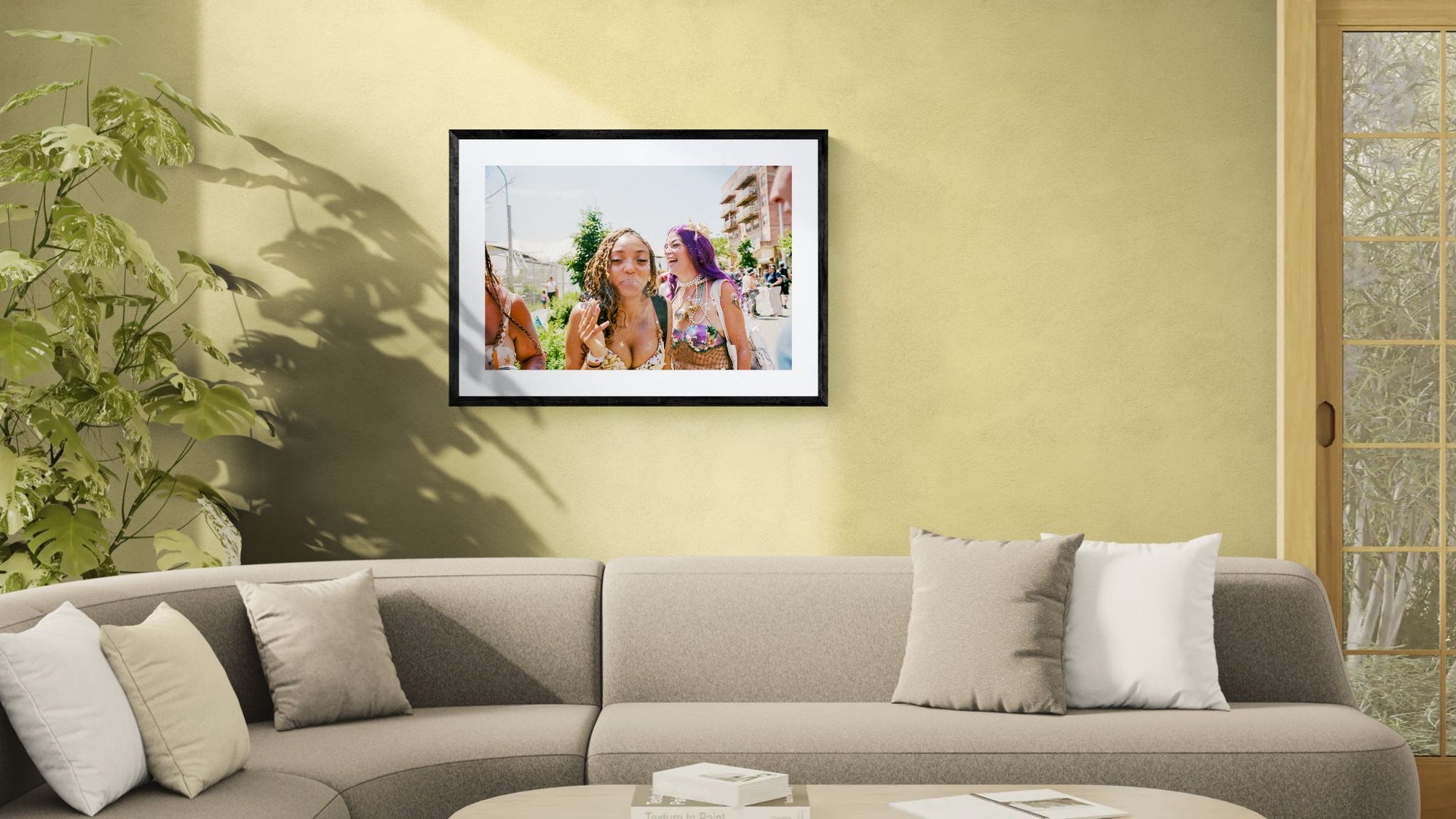 NYC Mermaid Parade Smoking & Laughing, Coney Island framed in black on a gallery wall with a viewer in a straw hat in front — Good Beans NYC.