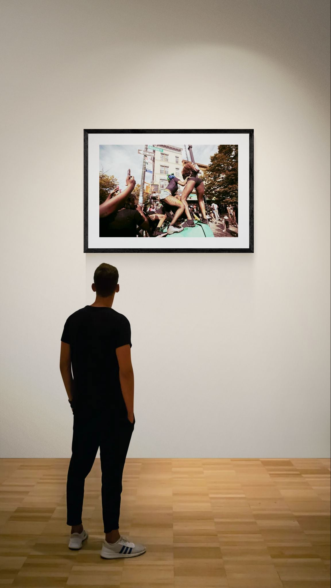 NYC J'Ouvert Twerking, Nostrand Avenue framed in black above a terracotta velvet sofa, gray plaster wall — Good Beans NYC.