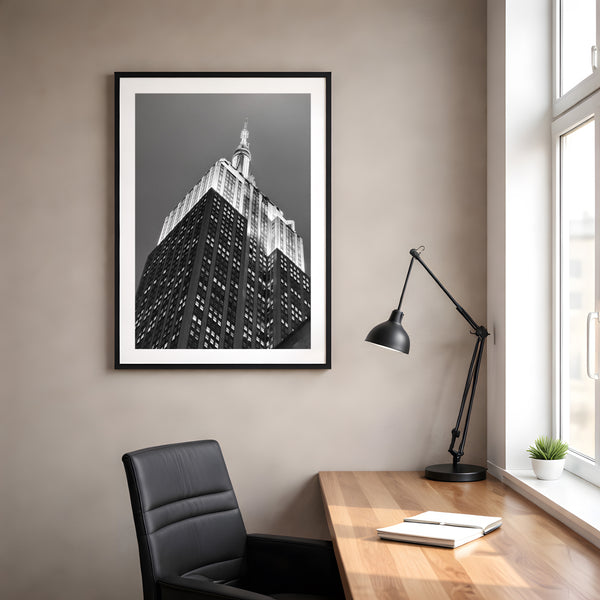 NYC Empire State Building, A Different Angle framed in black above a terracotta velvet sofa, gray plaster wall — Good Beans NYC.