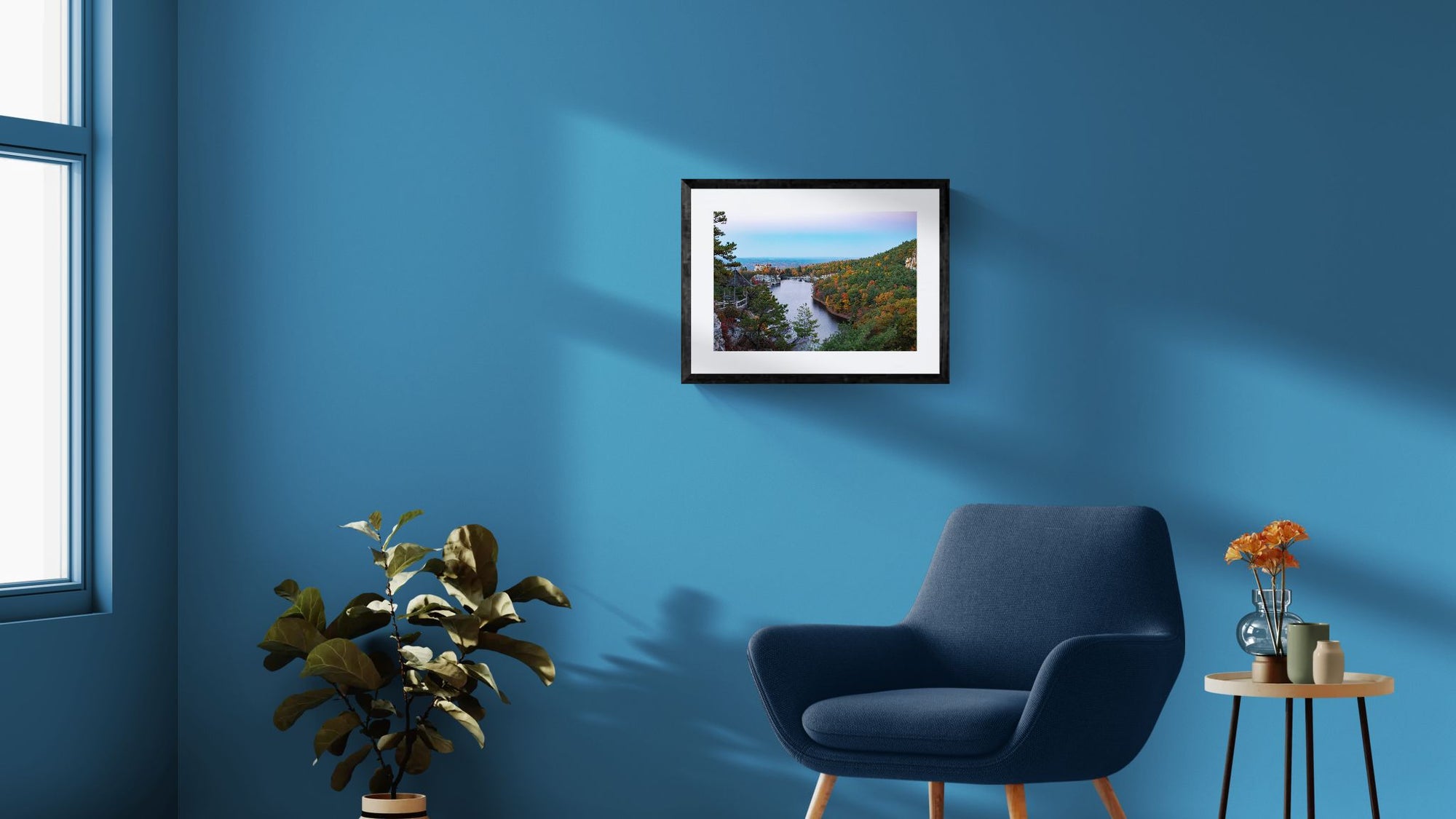 NY Mohonk Mountain House Fall, Hudson Valley framed in black on a gallery wall with a viewer in a straw hat in front — Good Beans NYC.