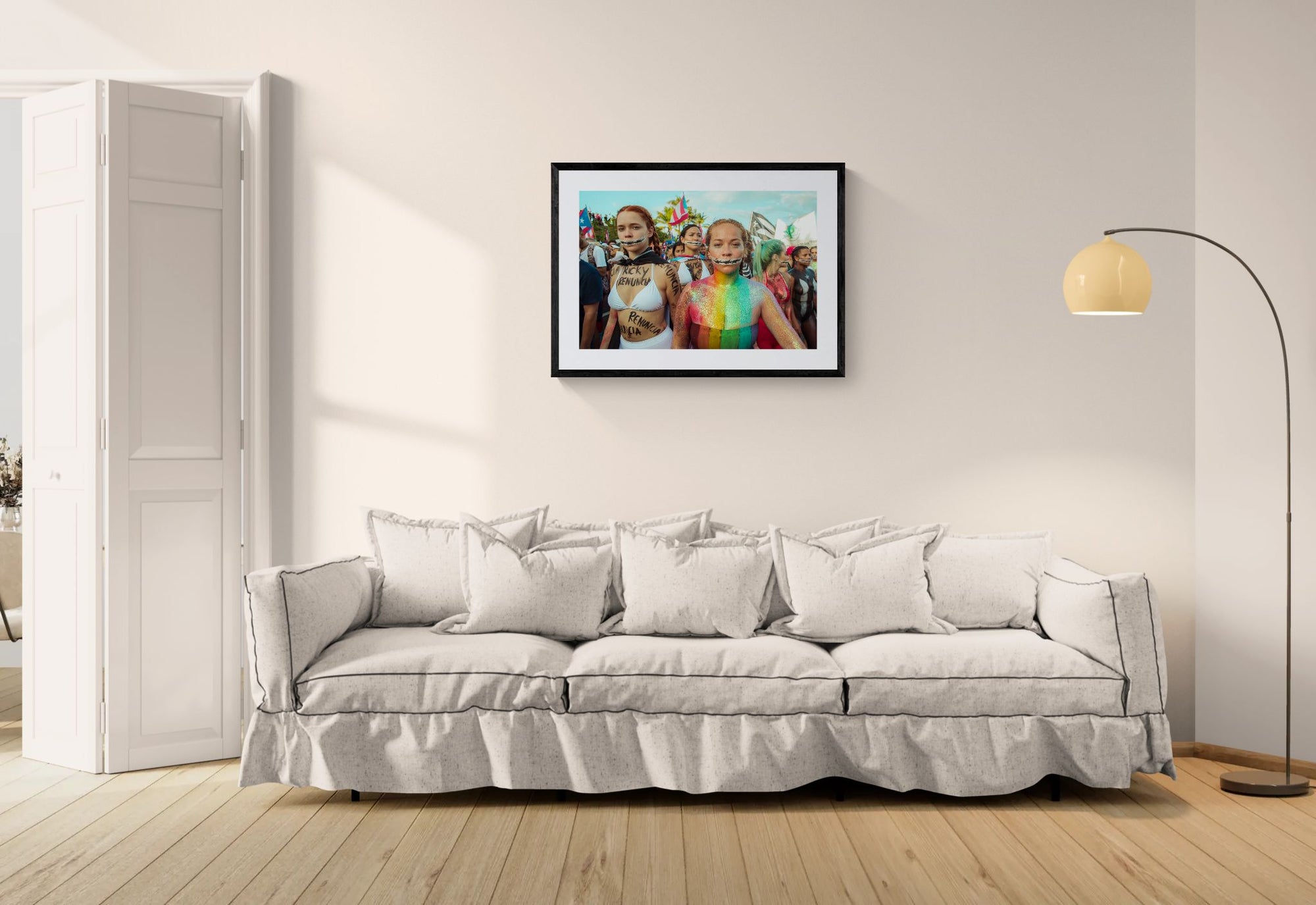 Puerto Rico Renuncia Body Paint Women, San Juan framed in black above a beige sofa, sunlit yellow plaster wall — Good Beans NYC.