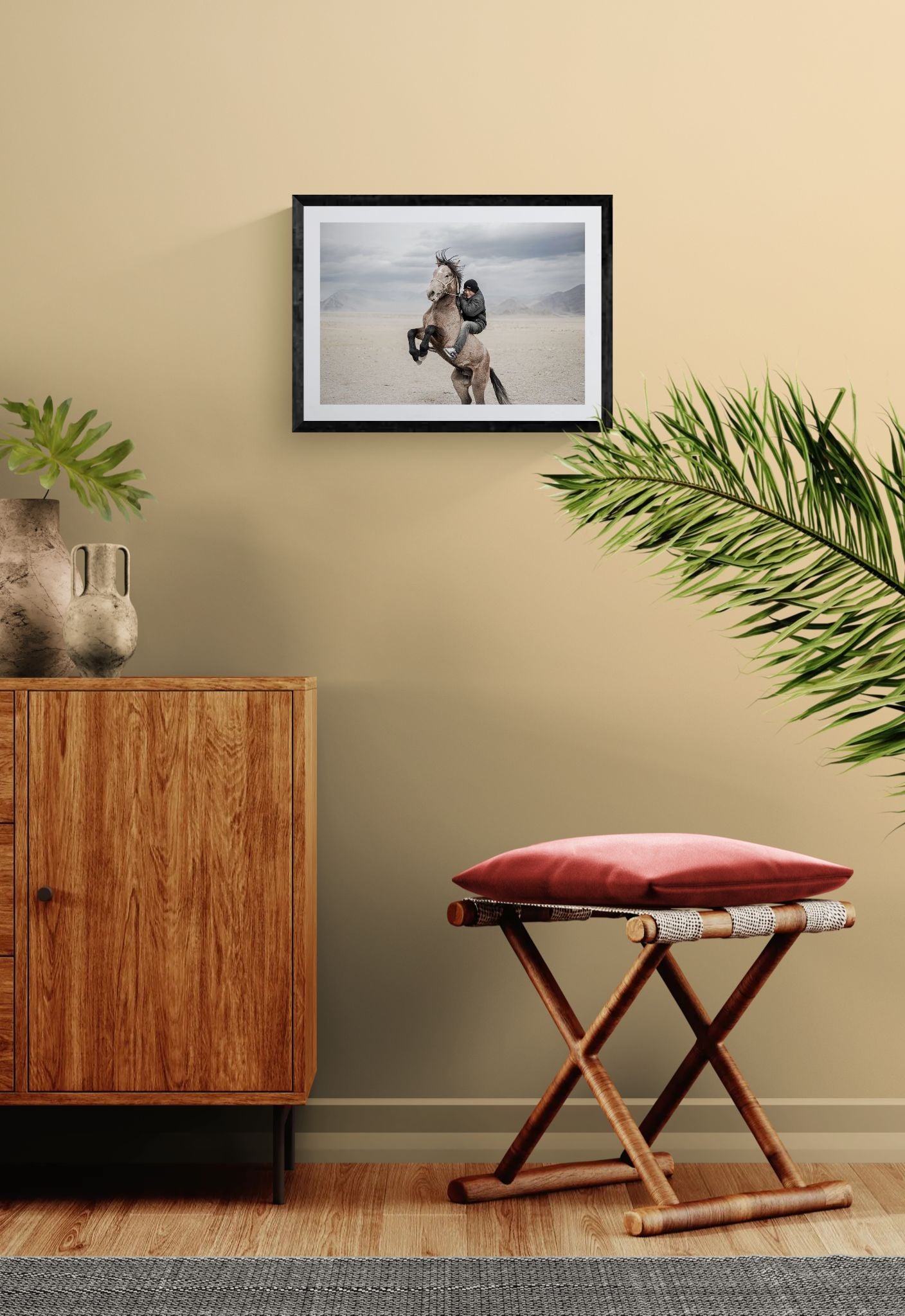 Mongolian Horse Rider, Bayan-Ölgii framed in black above a beige sofa, sunlit yellow plaster wall — Good Beans NYC.