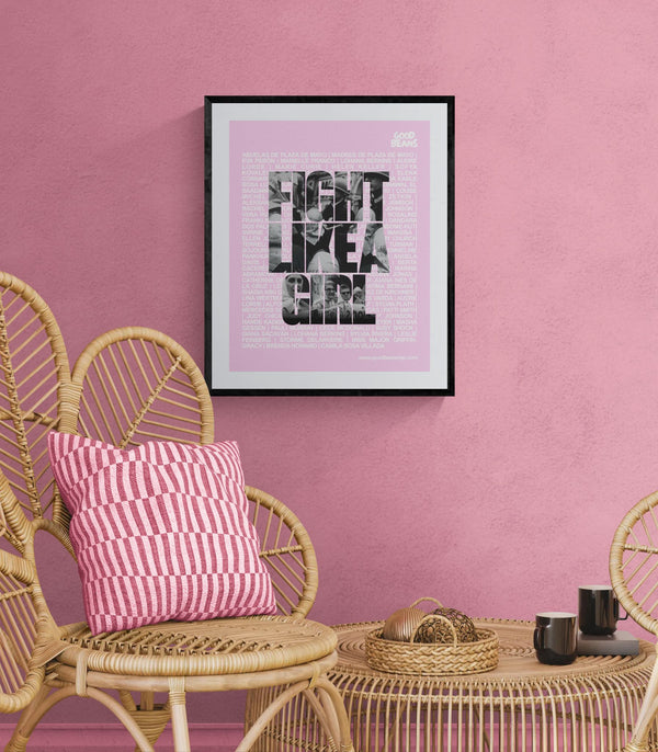 Fight Like a Girl Poster, Plaza de Mayo framed in black above a brown leather sectional, teal wall, gold pendant lamp — Good Beans NYC.