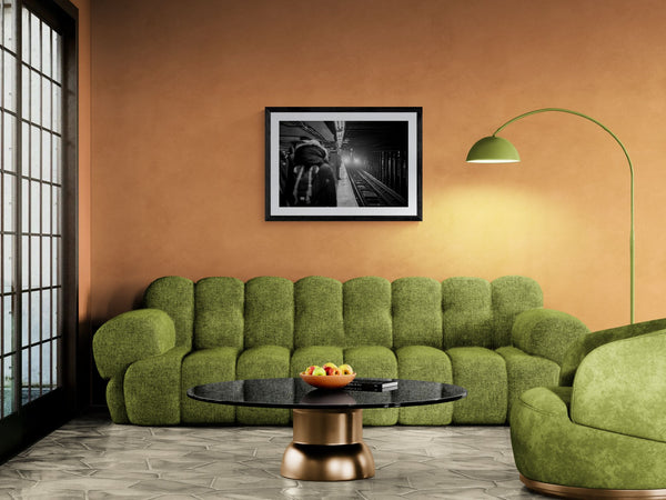 NYC Subway 5 Train Platform, Portals Series framed in black above a terracotta velvet sofa, gray plaster wall — Good Beans NYC.