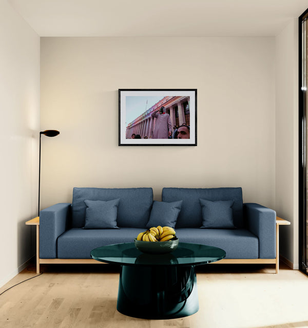 NYC Keffiyeh Protester at Penn Station framed in black above a terracotta velvet sofa, gray plaster wall — Good Beans NYC.