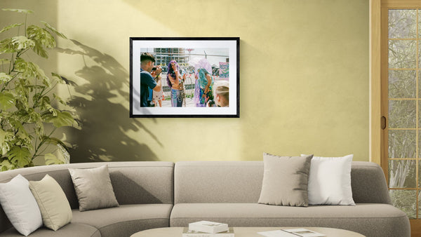 NYC Mermaid Parade Smoking, Coney Island framed in black on a gallery wall with a viewer in a straw hat in front — Good Beans NYC.
