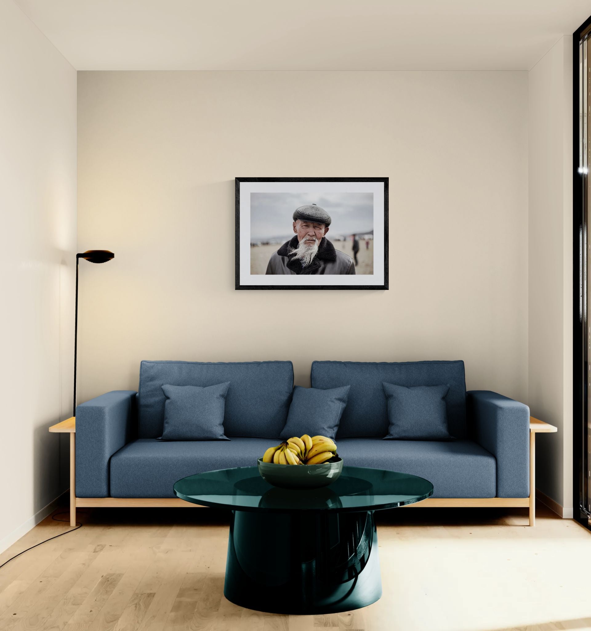 Old Mongolian Man Portrait, Bayan-Ölgii framed in black above a terracotta velvet sofa, gray plaster wall — Good Beans NYC.