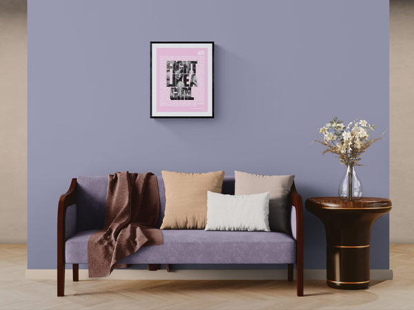 Fight Like a Girl Poster, Plaza de Mayo framed in black above a terracotta velvet sofa, gray plaster wall — Good Beans NYC.