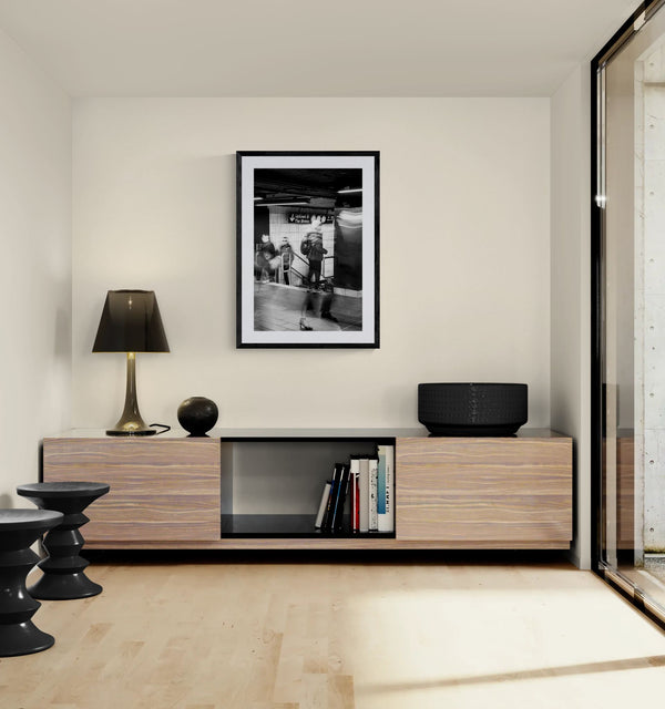 NYC Grand Central Motion, 4 5 6 Uptown framed in black on a gallery wall with a side-profile viewer in a dark coat — Good Beans NYC.