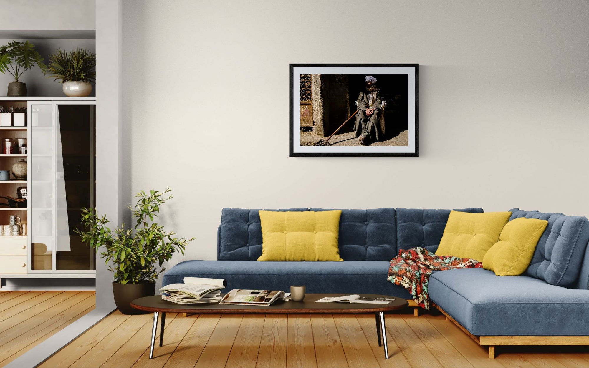 Egypt Old Man with Cane, Cairo's Garbage City framed in black above a beige sofa, sunlit yellow plaster wall — Good Beans NYC.