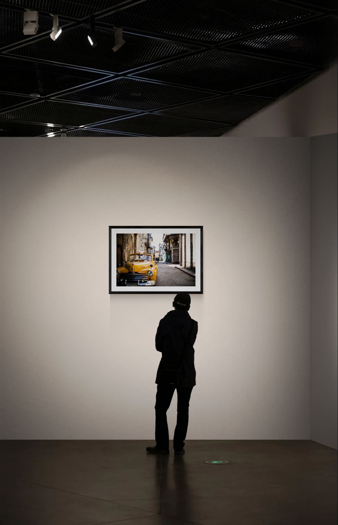 Cuba Taxi, Old Havana framed in black on a gallery wall with a side-profile viewer in a dark coat — Good Beans NYC.