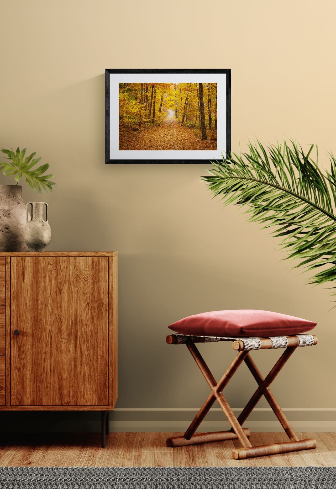NY Fall Forest, Hudson Valley — New Paltz framed in black above a beige sofa, sunlit yellow plaster wall — Good Beans NYC.