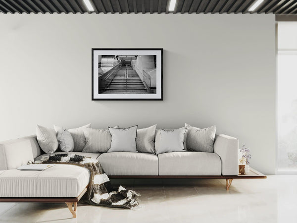 NYC Subway Grand Central Emptiness, Portals Series framed in black on a gallery wall with a viewer in a straw hat in front — Good Beans NYC.