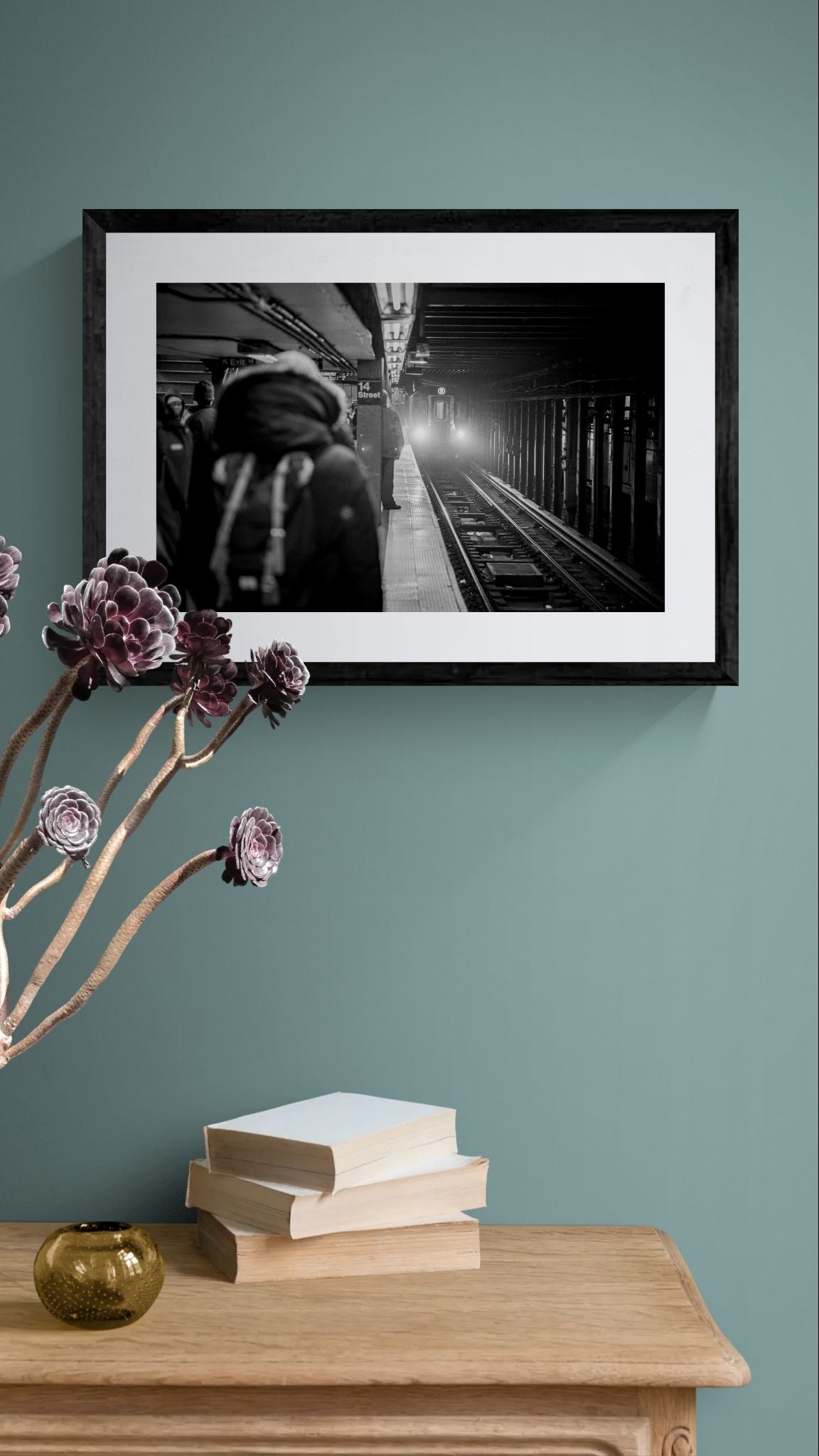 NYC Subway 5 Train Platform, Portals Series framed in black above a brown leather sectional, teal wall, gold pendant lamp — Good Beans NYC.
