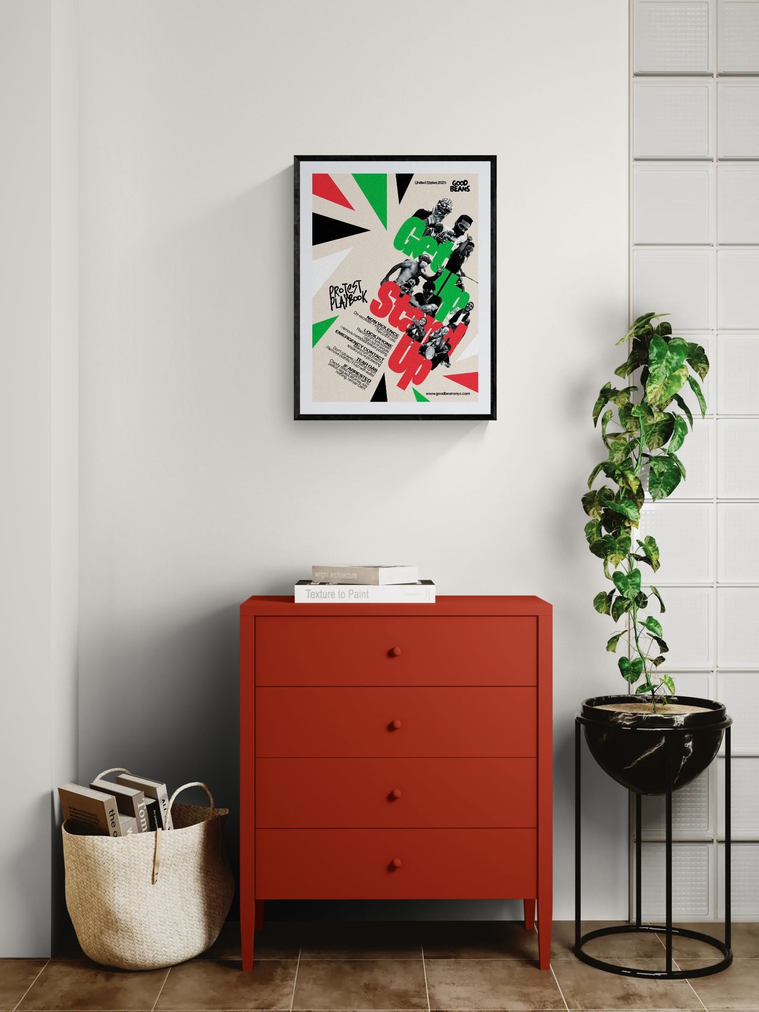 Get In Stand Up Protest Playbook Poster framed in black on a gallery wall with a viewer in a straw hat in front — Good Beans NYC.